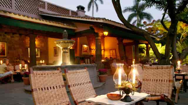 Upscale Las Mañanitas outdoor venue with ambient lighting for cocktail receptions and networking.