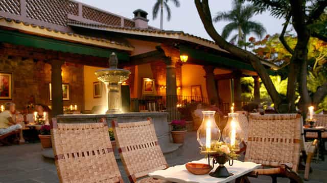 Upscale Las Mañanitas outdoor venue with ambient lighting for cocktail receptions and networking.