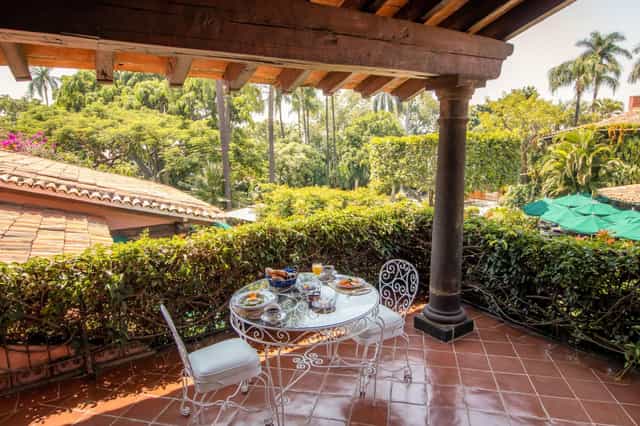 Covered terrace at Las Mañanitas featuring colonial architecture for luxury boutique events.