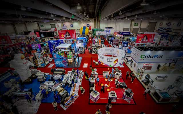 Trade show floor at Citibanamex Center with hanging signage for exhibition hall event planning.