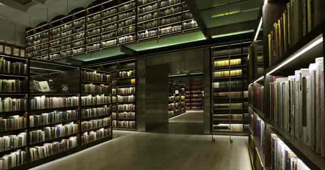 Elegant INEHRM library venue with dramatic lighting for exclusive evening receptions and VIP events.