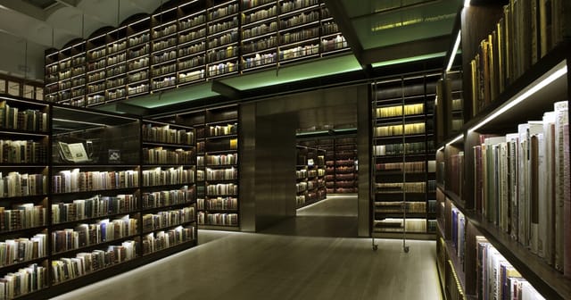 Elegant INEHRM library venue with dramatic lighting for exclusive evening receptions and VIP events.