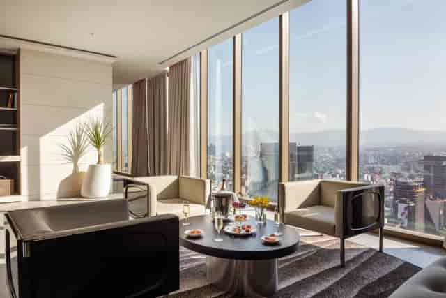 Executive suite with floor-to-ceiling windows for VIP meetings and corporate networking.