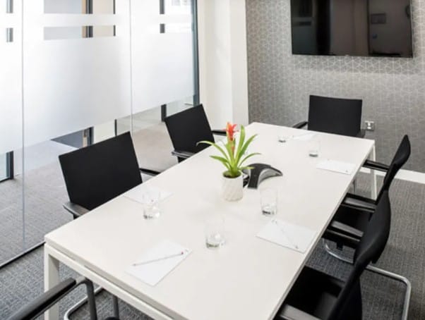 Modern boardroom for 4 at Spaces Revolucion 1877; turnkey executive meeting space rental.
