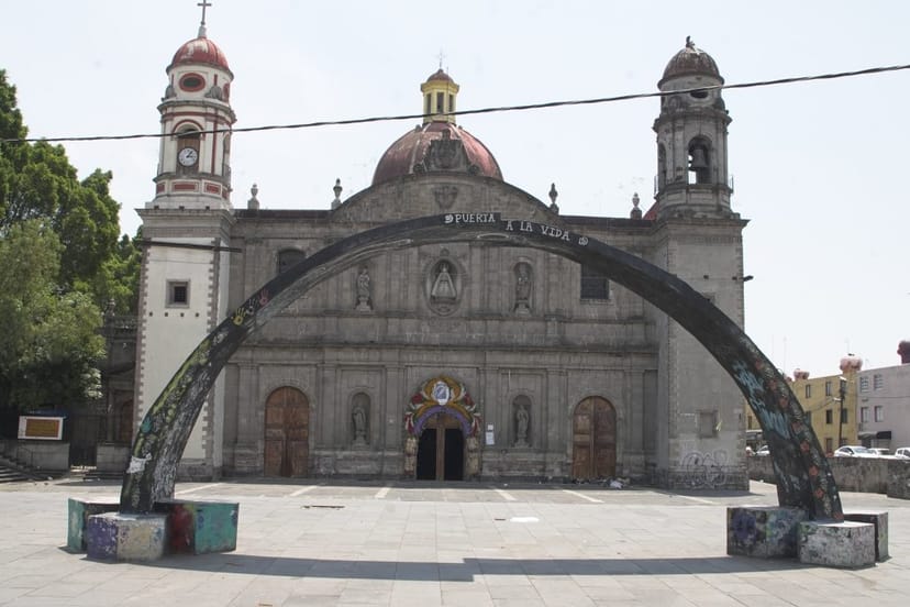 Historic arch at Plaza de la Soledad venue for outdoor event styling and rustic wedding photography.