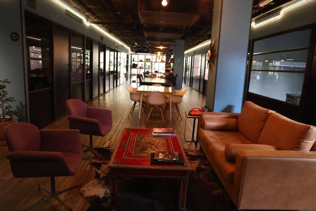 Industrial podcast room with chic decor, perfect for creative co-working and networking events.