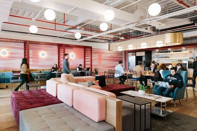 Modern hybrid workspace with lounge seating for corporate offsite and coworking events.