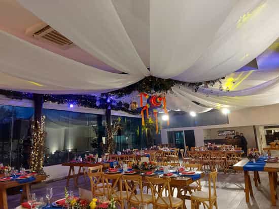 Terraza La Plaza banquet hall with rustic tables and piñata for festive event venue celebration.