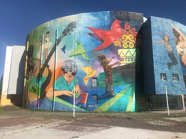 Casa de Las Bombas mural facade: vibrant venue for cultural events and creative exhibitions.