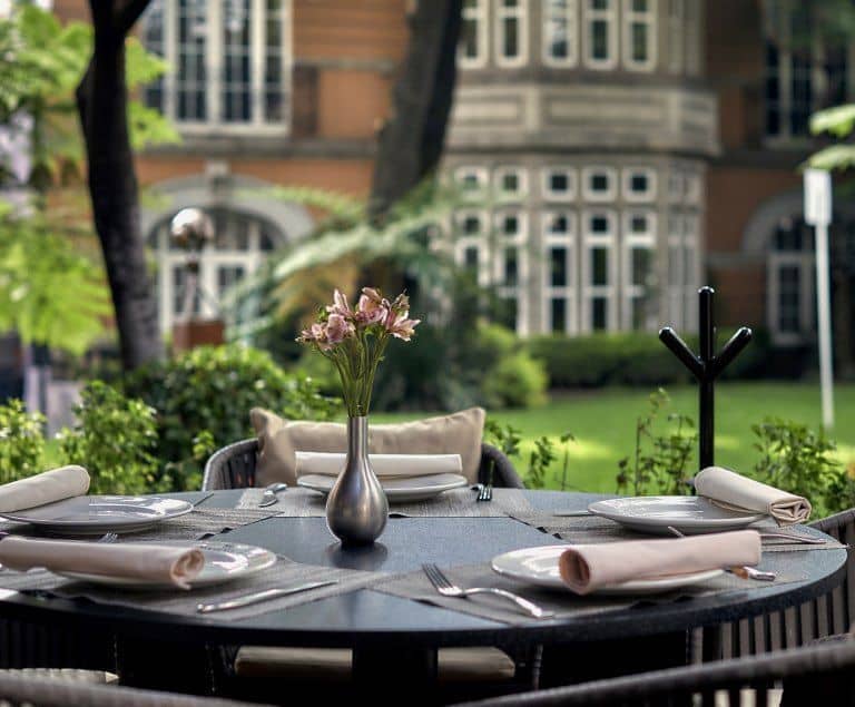 Upscale outdoor garden banquet setting for an elegant brunch or executive networking luncheon.