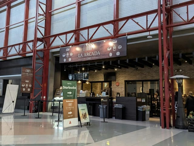 La Arcada 1200 onsite cafe, featuring directional signage for event networking and coffee breaks.