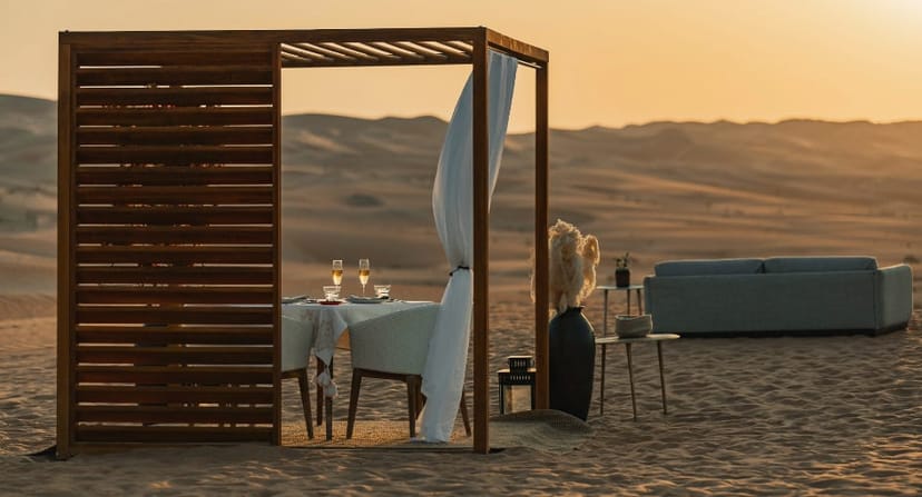Luxury desert dining set-up at sunset for exclusive VIP incentive travel events.