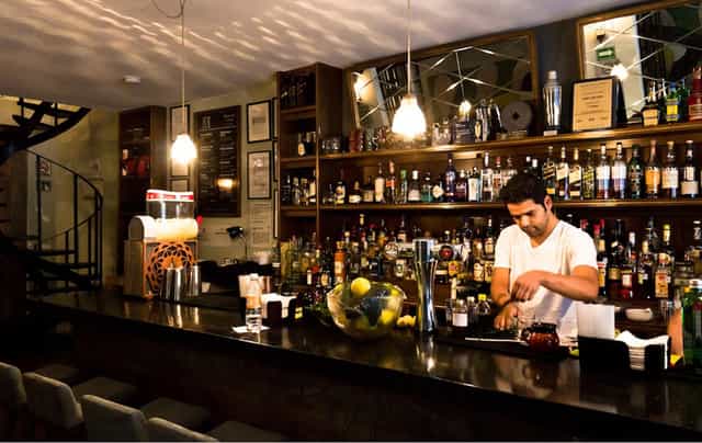 Upscale Limantour cocktail bar with warm lighting for corporate events and networking receptions.