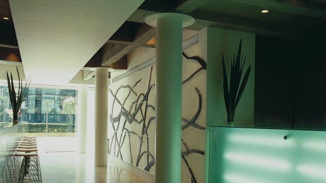 Modern hotel business center with illuminated bar for evening cocktail receptions.