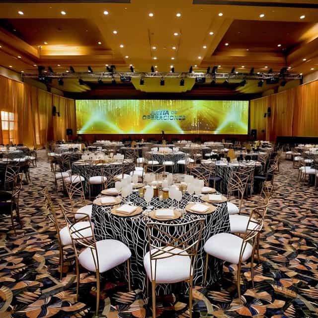 Grand Master Ballroom gala with LED backdrop, luxury table settings, and gold chairs.