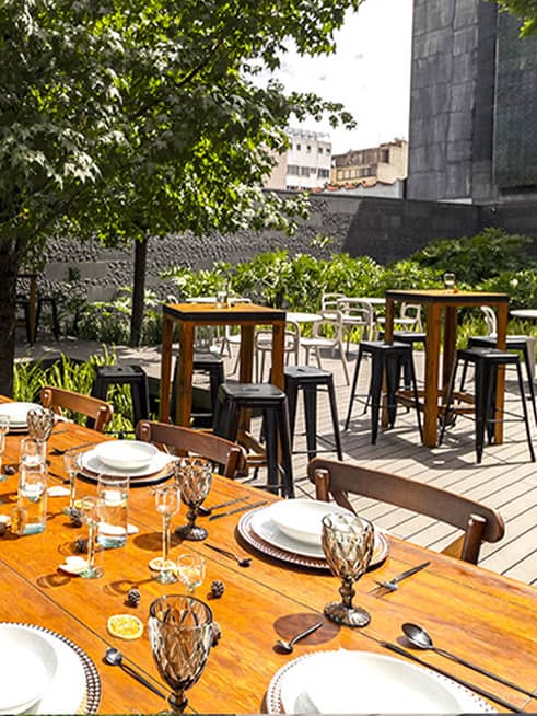 Outdoor event terrace with bistro tables for cocktail hours and social gatherings.