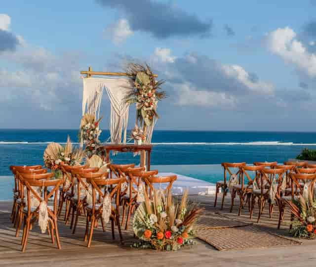 The Fives Room infinity backdrop with boho-chic decor for destination wedding ceremony.