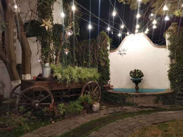 Rustic-chic Hacienda de San Nicolás outdoor event space with bistro lighting for soirées.