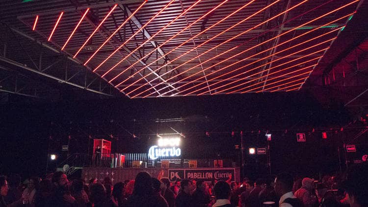 Pabellón Oeste corporate event with linear lighting for brand activation and evening gala.