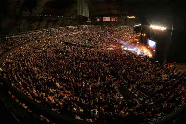 Full stadium event at Palacio de los Deportes with massive AV production and sold-out crowd.