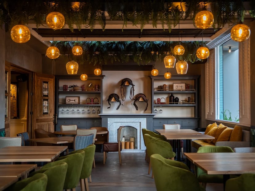 Private dining room at Casa D'Amico with warm pendant lighting for corporate dinners and receptions.