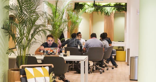 Modern biophilic meeting room for agile team huddles and coworking breakout sessions.