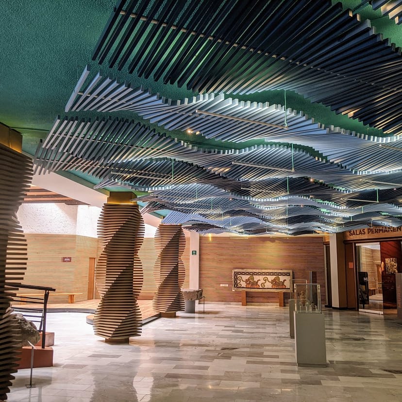 Agora event space, architectural ceiling, premium registration, networking reception venue.