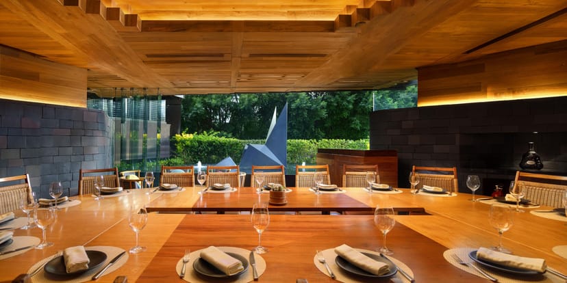 Executive boardroom with U-shaped table and city view for corporate meetings and business events.