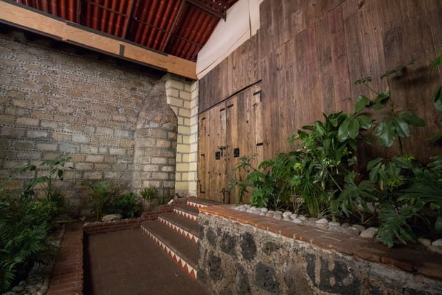 Patio Pirul venue with rustic stone and timber, perfect for atmospheric cocktail hours and dinners.