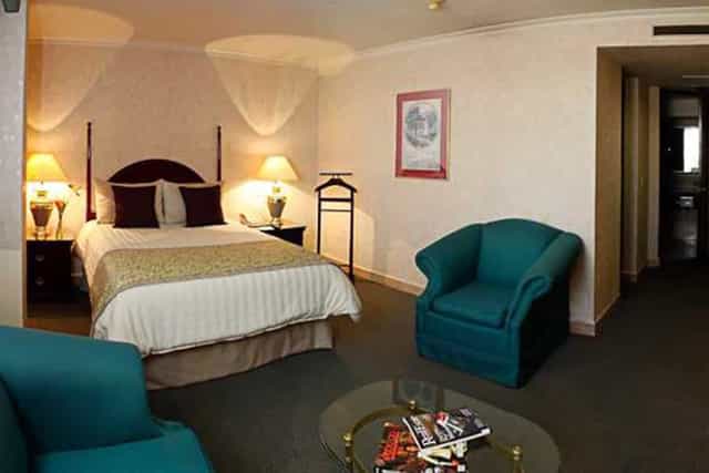 Standard suite at Hotel Pedregal Palace with dated decor for business travel or hotel bookings.
