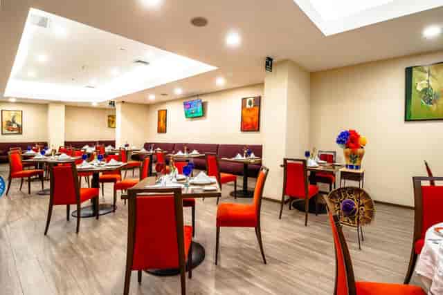 Red chairs in a Camino Real Aeropuerto banquet hall for corporate events and private dining.