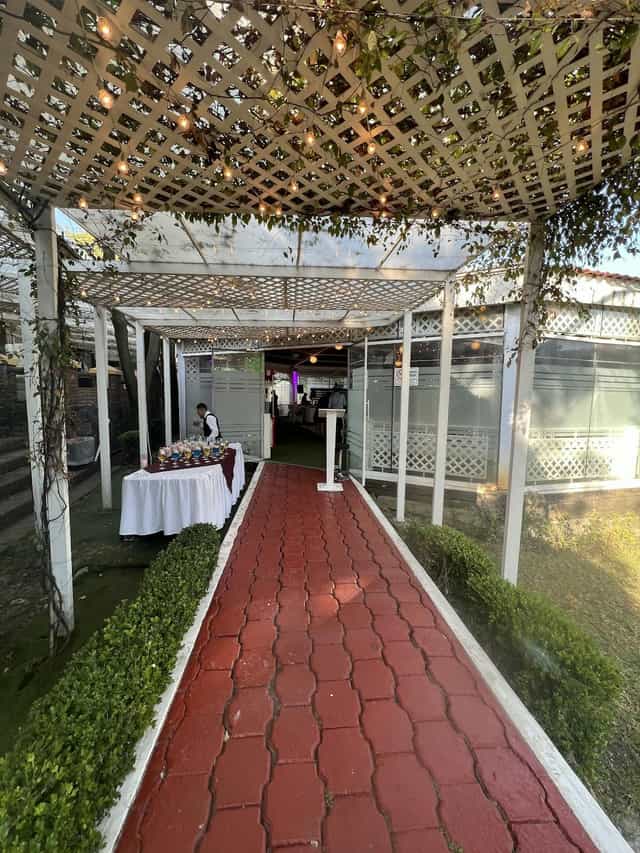 Outdoor event registration and bar area at Lienzo Charro La Tapatía venue.