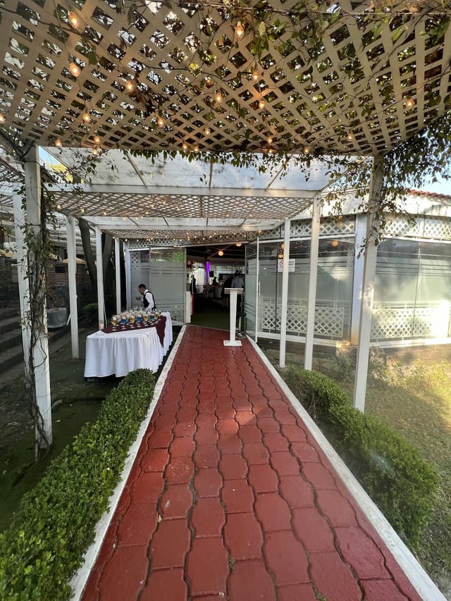 Outdoor event registration and bar area at Lienzo Charro La Tapatía venue.