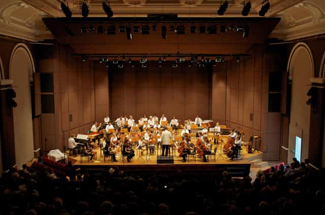 Orchestra performing on Main Hall proscenium stage at Chorus jazz concert venue in Lausanne.