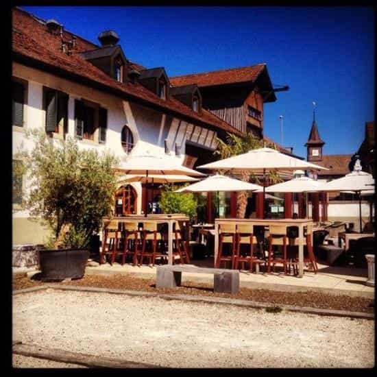 Outdoor networking reception at Galion Pub with high-top seating and modern parasols.