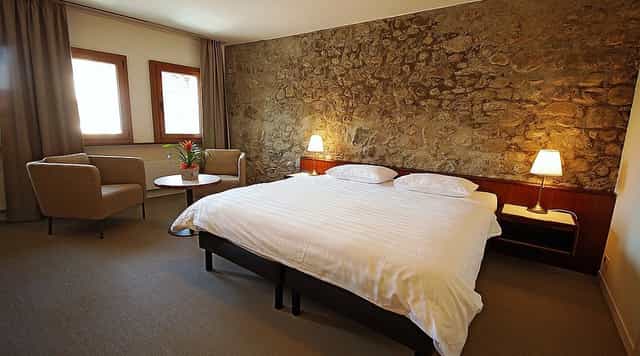 Boutique hotel room with stone accents for high-end retreat accommodations and business events.