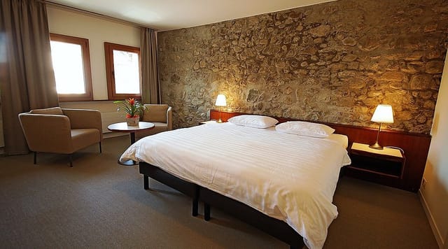 Boutique hotel room with stone accents for high-end retreat accommodations and business events.