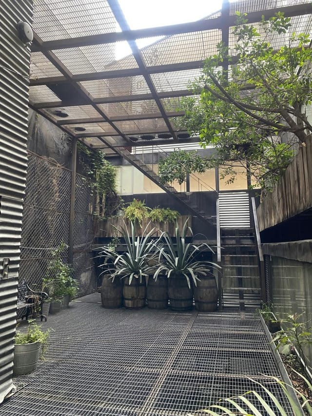 Industrial-chic art gallery courtyard for boutique cocktail receptions and corporate events.