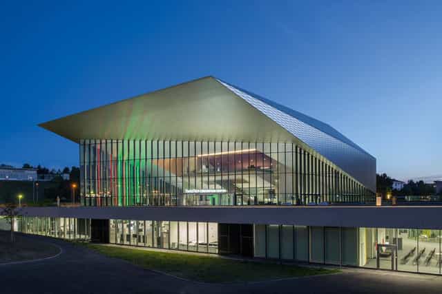 Modern SwissTech Convention Center foyer with glass walls for professional corporate conferences.