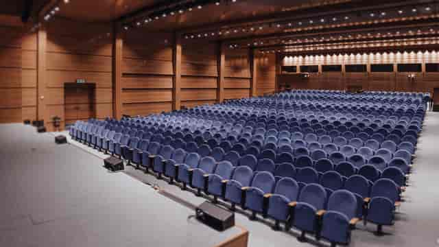 Beaulieu Lausanne wood-paneled auditorium with tiered seating for conferences and trade events.