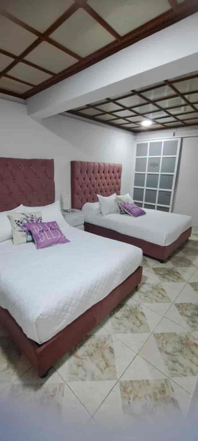 Double-occupancy hotel room at Suites del Valle for conference accommodation.