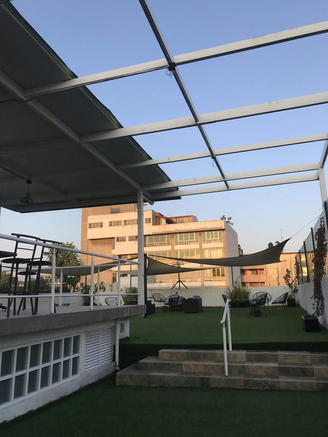 Industrial rooftop venue with outdoor seating for corporate networking and cocktail events.