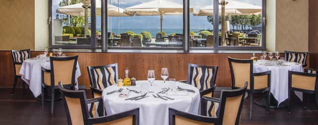 Luxury waterfront dining lounge at Hôtel Angleterre for executive retreats and client lunches.
