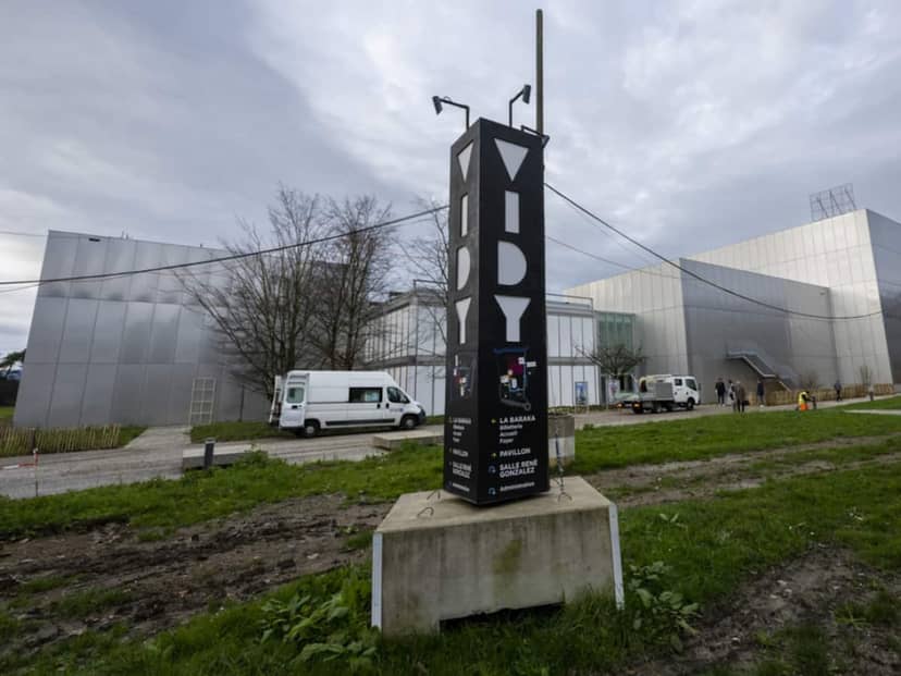 Brutalist exterior of La Passerelle, Théâtre Vidy-Lausanne with muddy event venue access.