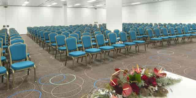 Auditorium at Aquatis Hotel: Theater-style ballroom with columns for corporate events or meetings.