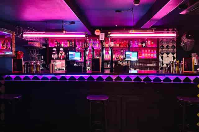 Neon-lit bar at Behind Closed Doors, ideal for evening reception and networking event venue.