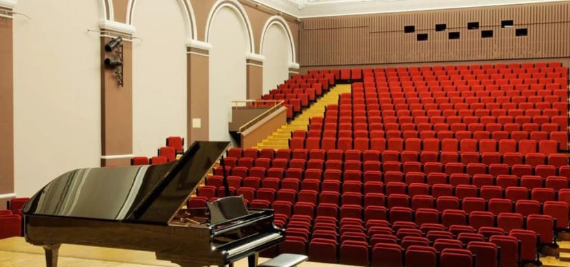 Salle des Fêtes auditorium with red seating, ideal for corporate keynote events or live concerts.