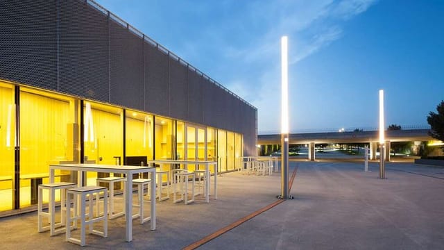 Modern Starling Hotel Lausanne conference center with high-top seating for networking events.