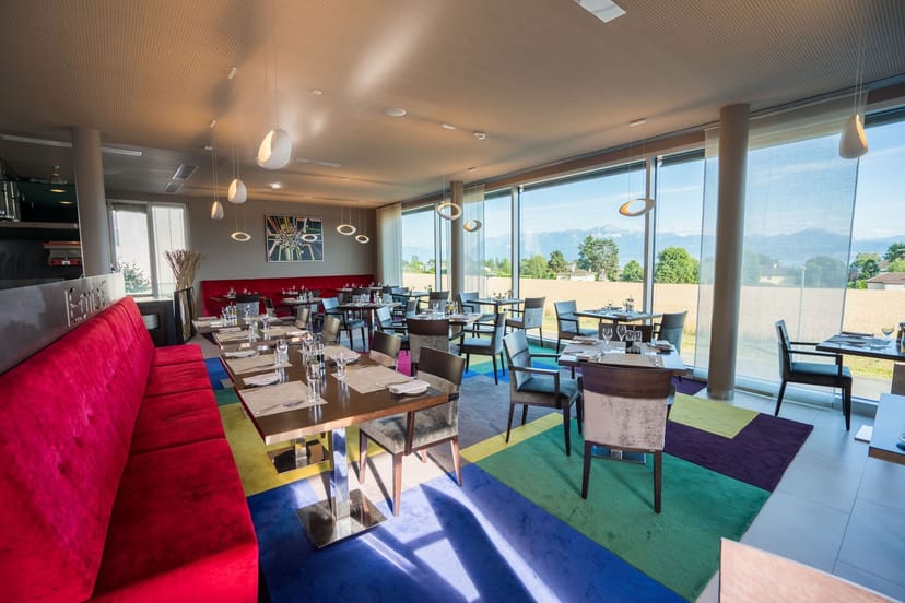 Corporate luncheon setup at Starling Hotel Lausanne with natural views and vibrant decor.