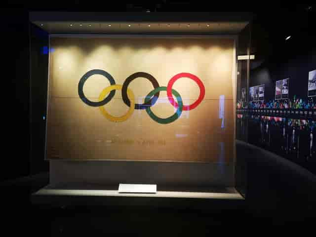Olympic Museum gallery exhibit with glass display cases for brand curation and corporate events.